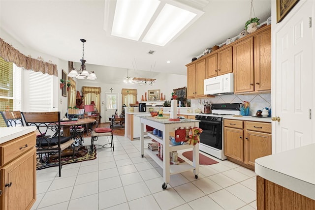 16535 Mccormick Dr, Houston, TX 77095 - kitchen featuring white appliances, light countertops, a chandelier, and decorative backsplash
