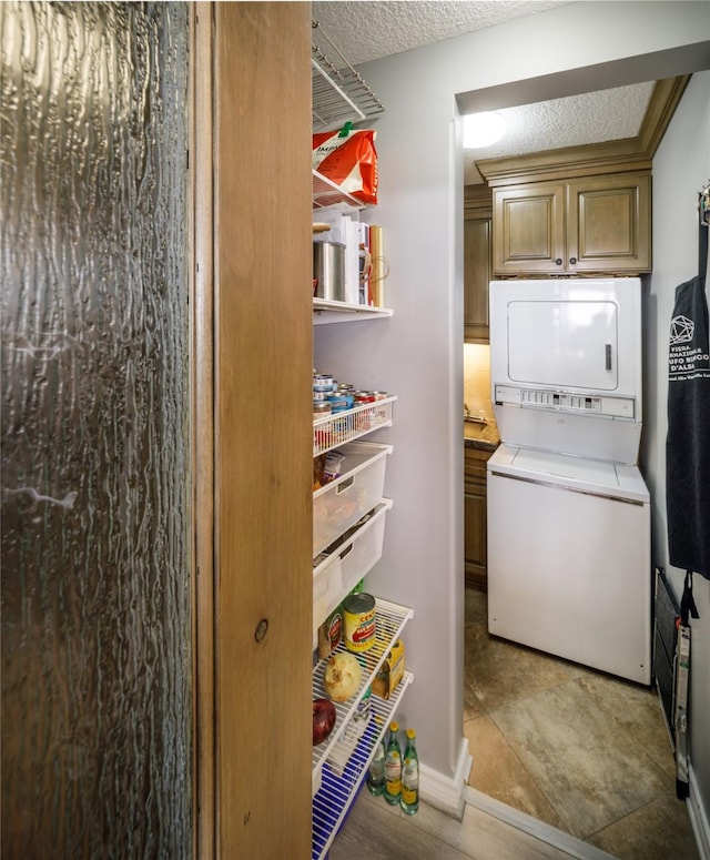 5001 Woodway Dr Unit 1704, Houston, TX 77056 - pantry featuring stacked washer and clothes dryer