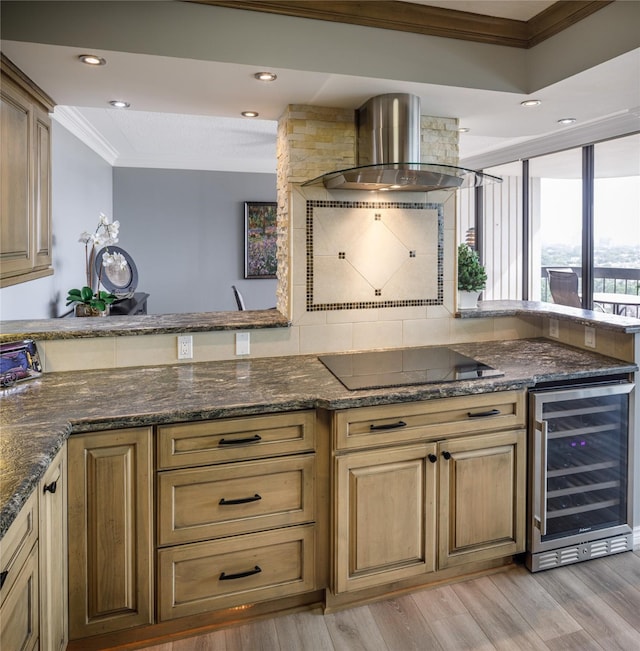 5001 Woodway Dr Unit 1704, Houston, TX 77056 - kitchen with beverage cooler, black electric stovetop, ornamental molding, wall chimney exhaust hood, and light wood-type flooring