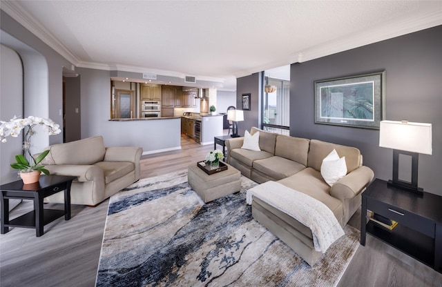 5001 Woodway Dr Unit 1704, Houston, TX 77056 - living area featuring crown molding and light wood-type flooring