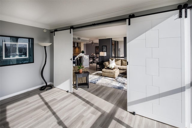 5001 Woodway Dr Unit 1704, Houston, TX 77056 - living area featuring a barn door, wood finished floors, and crown molding
