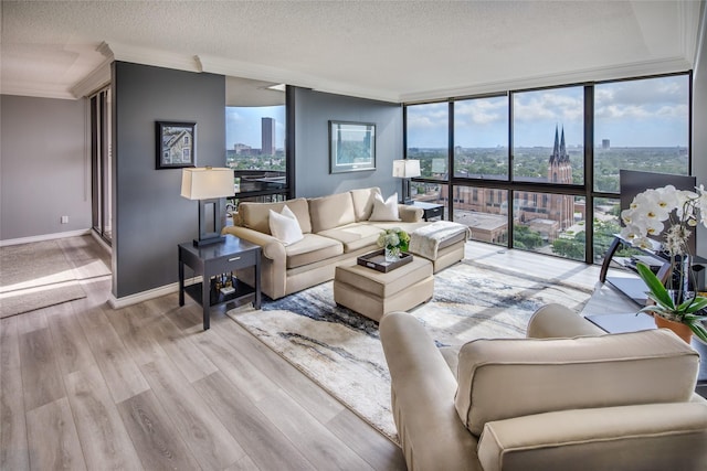 5001 Woodway Dr Unit 1704, Houston, TX 77056 - living room with a wall of windows, ornamental molding, light wood-type flooring, and a textured ceiling