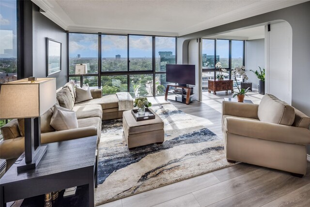 5001 Woodway Dr Unit 1704, Houston, TX 77056 - living area with expansive windows, wood finished floors, and crown molding