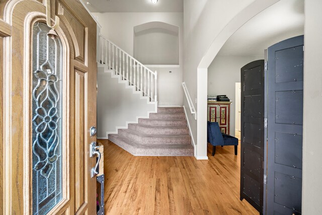 14711 Trailbrook Dr, Houston, TX 77095 - foyer featuring light wood finished floors, stairs, and arched walkways