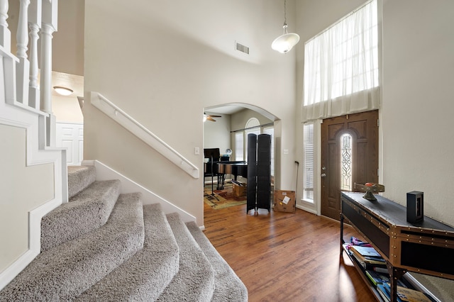 14711 Trailbrook Dr, Houston, TX 77095 - entryway featuring a high ceiling, wood finished floors, plenty of natural light, arched walkways, and stairway