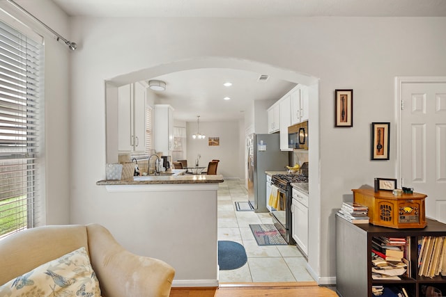 14711 Trailbrook Dr, Houston, TX 77095 - kitchen featuring stainless steel range with gas stovetop, black microwave, plenty of natural light, and recessed lighting
