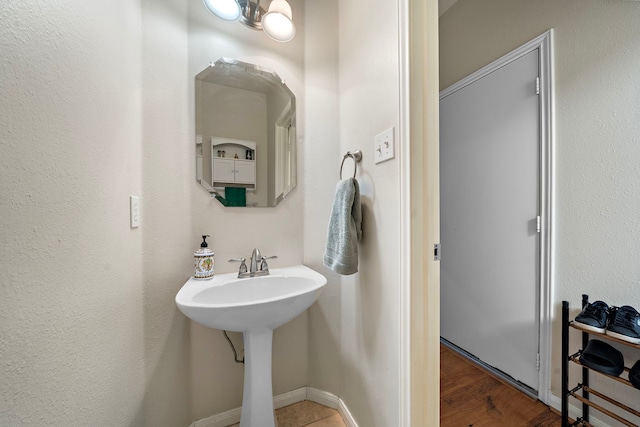 14711 Trailbrook Dr, Houston, TX 77095 - bathroom featuring a sink and baseboards