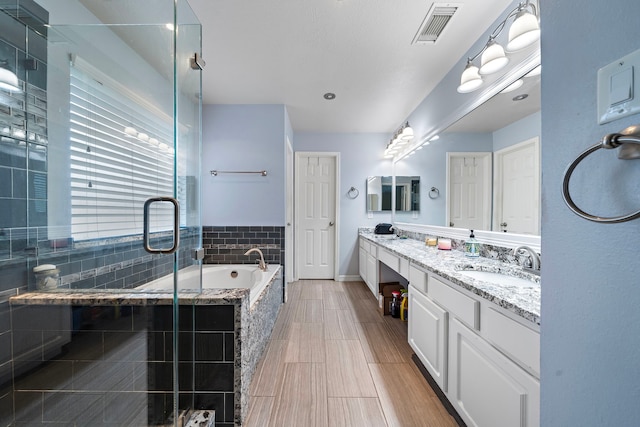 14711 Trailbrook Dr, Houston, TX 77095 - bathroom featuring double vanity, a bath, and a shower stall