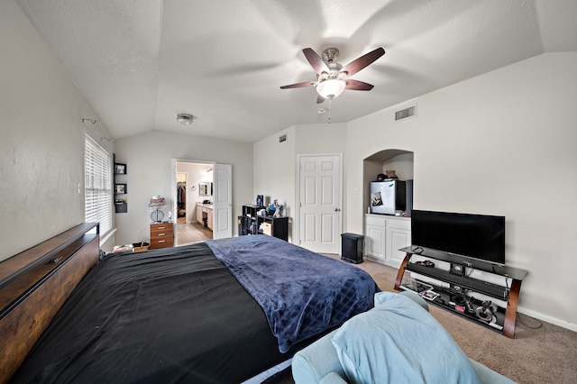 14711 Trailbrook Dr, Houston, TX 77095 - bedroom with vaulted ceiling, light colored carpet, connected bathroom, ceiling fan, and arched walkways