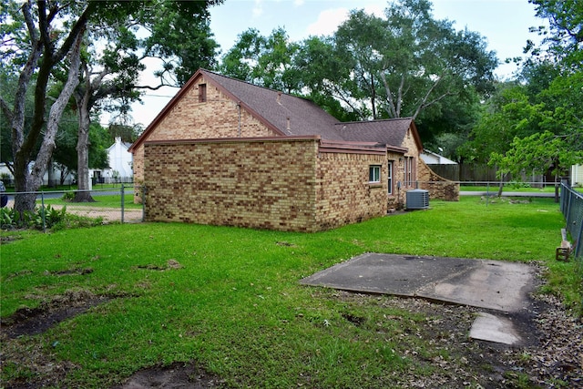 801 Erin St, El Campo, TX 77437 - view of home's exterior featuring brick siding and a fenced backyard