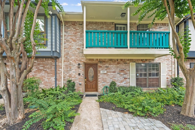 14708 Perthshire Rd Unit F, Houston, TX 77079 - view of exterior entry with a balcony and brick siding