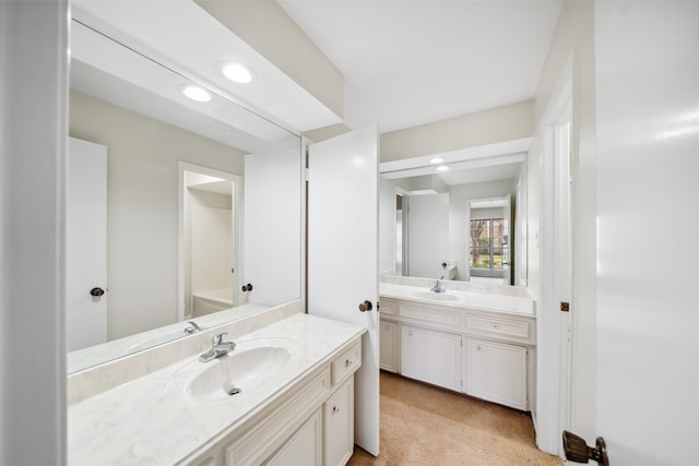 14708 Perthshire Rd Unit F, Houston, TX 77079 - bathroom featuring two vanities and recessed lighting