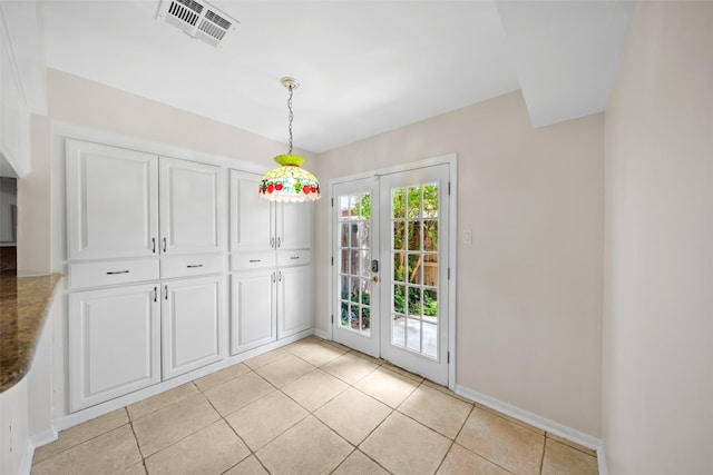 14708 Perthshire Rd Unit F, Houston, TX 77079 - unfurnished dining area featuring french doors and light tile patterned floors