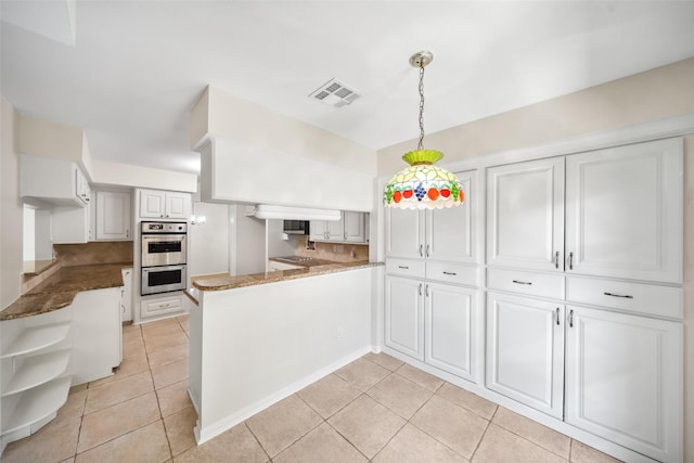 14708 Perthshire Rd Unit F, Houston, TX 77079 - kitchen featuring double oven, a peninsula, light tile patterned floors, and decorative backsplash
