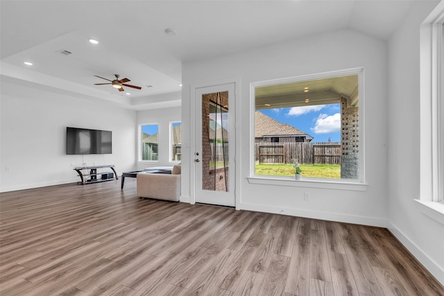 10614 Hazel Hills Dr, Cypress, TX 77433 - unfurnished living room with wood finished floors, ceiling fan, a tray ceiling, and recessed lighting