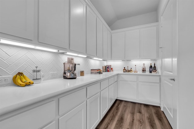 10614 Hazel Hills Dr, Cypress, TX 77433 - kitchen featuring white cabinetry, tasteful backsplash, lofted ceiling, light countertops, and dark wood-style floors