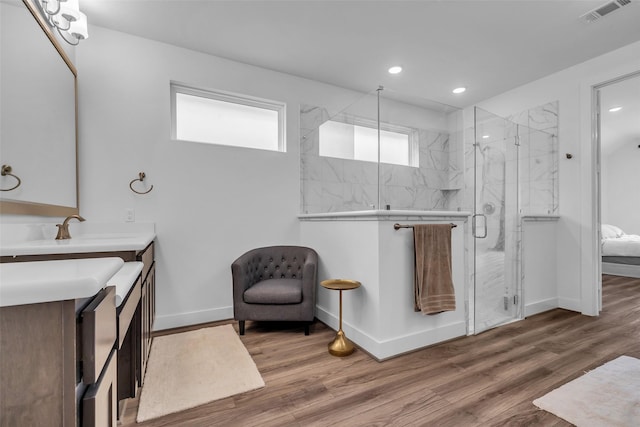10614 Hazel Hills Dr, Cypress, TX 77433 - bathroom with vanity, a marble finish shower, wood finished floors, and recessed lighting