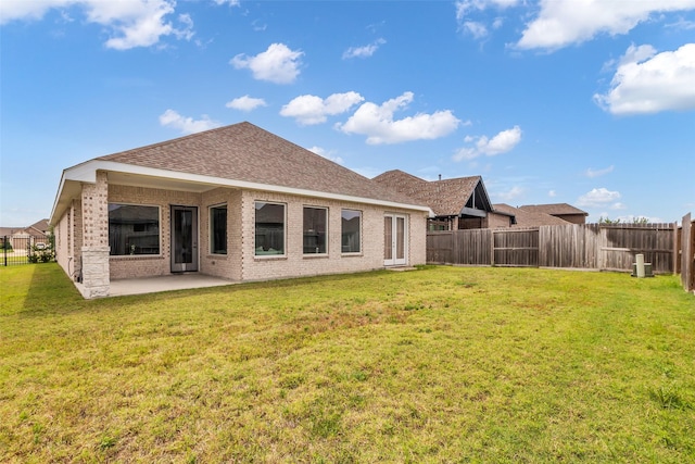10614 Hazel Hills Dr, Cypress, TX 77433 - rear view of house with brick siding, a fenced backyard, a patio area, and a shingled roof