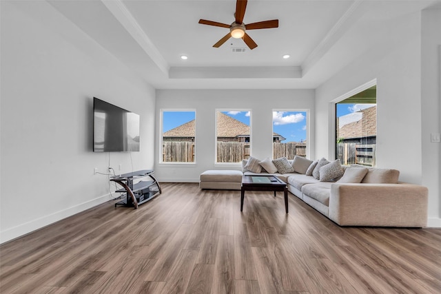 10614 Hazel Hills Dr, Cypress, TX 77433 - living area featuring a raised ceiling, plenty of natural light, wood finished floors, crown molding, and recessed lighting