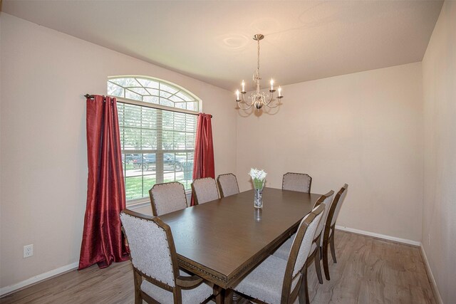 1911 Vineyard Bend Ct, Pearland, TX 77581 - dining area featuring a chandelier and light wood-type flooring
