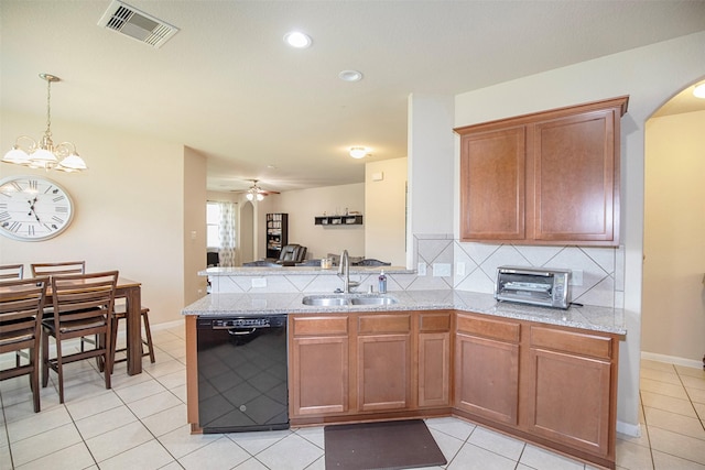 1911 Vineyard Bend Ct, Pearland, TX 77581 - kitchen featuring dishwasher, arched walkways, backsplash, a peninsula, and light tile patterned floors