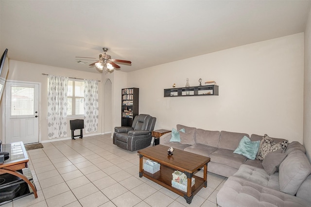 1911 Vineyard Bend Ct, Pearland, TX 77581 - living room with light tile patterned floors, a ceiling fan, and arched walkways