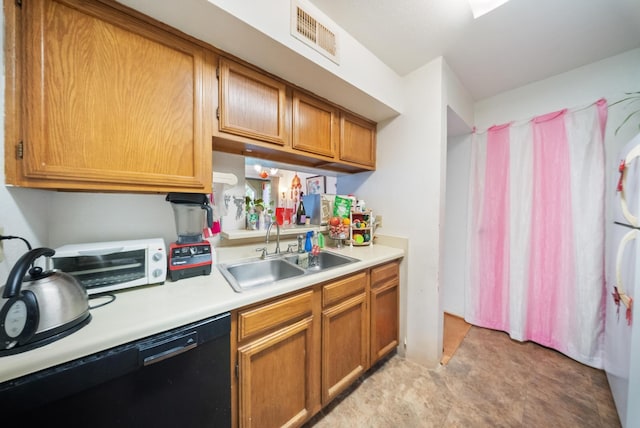 6602 Harbor Town Dr Unit 506, Houston, TX 77036 - kitchen with black dishwasher, light countertops, brown cabinetry, and freestanding refrigerator