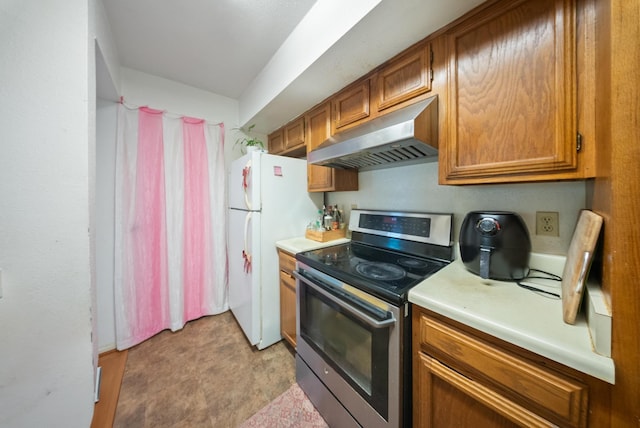 6602 Harbor Town Dr Unit 506, Houston, TX 77036 - kitchen with extractor fan, electric range, brown cabinetry, light countertops, and freestanding refrigerator