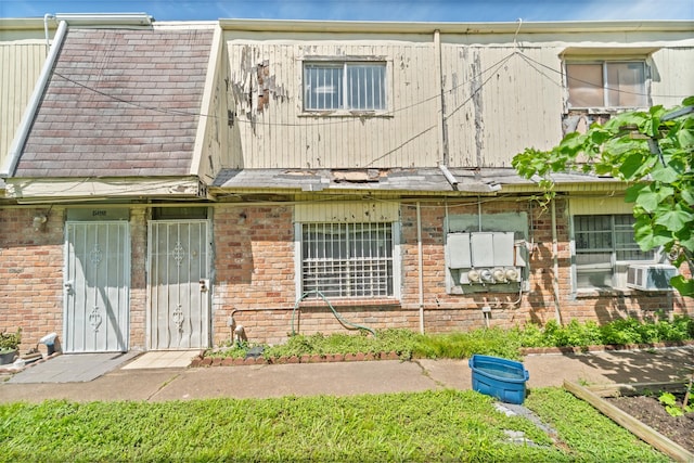 5700 Brookglen Dr Unit 565, Houston, TX 77017 - view of property featuring brick siding, cooling unit, and roof with shingles