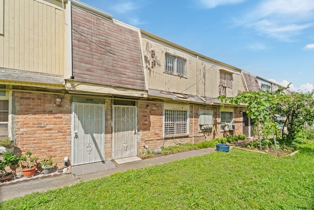 5700 Brookglen Dr Unit 565, Houston, TX 77017 - rear view of property featuring brick siding and a lawn