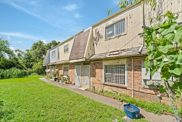 5700 Brookglen Dr Unit 565, Houston, TX 77017 - rear view of house with a lawn and brick siding