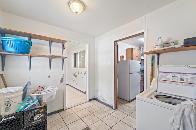 5700 Brookglen Dr Unit 565, Houston, TX 77017 - washroom featuring washer / dryer and light tile patterned floors