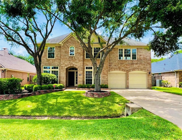 22 Crestview Trl, Houston, TX 77082 - colonial house with driveway, a front yard, an attached garage, and brick siding