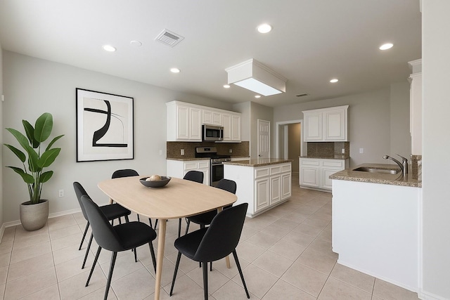 22 Crestview Trl, Houston, TX 77082 - dining area with light tile patterned floors and recessed lighting
