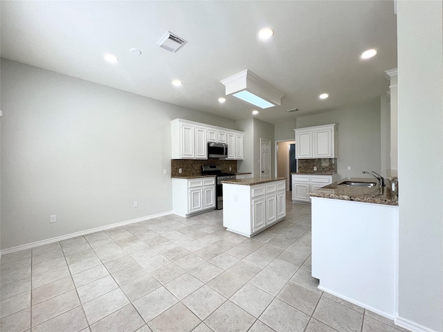 22 Crestview Trl, Houston, TX 77082 - kitchen with appliances with stainless steel finishes, decorative backsplash, dark stone counters, light tile patterned floors, and recessed lighting