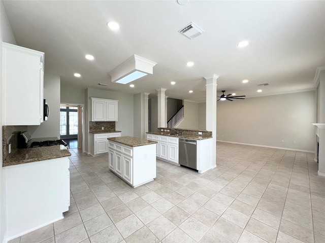 22 Crestview Trl, Houston, TX 77082 - kitchen with ornate columns, stainless steel dishwasher, light tile patterned floors, open floor plan, and recessed lighting