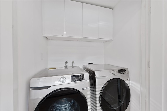 7807 Ella Lee Ln, Houston, TX 77063 - washroom with washing machine and clothes dryer and cabinet space