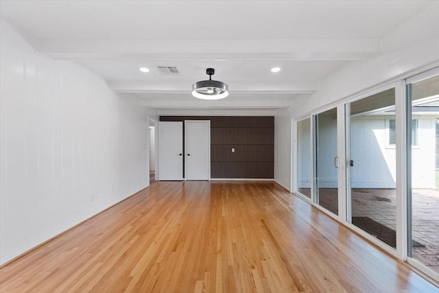 7807 Ella Lee Ln, Houston, TX 77063 - unfurnished bedroom featuring beam ceiling, light wood-style floors, and two closets
