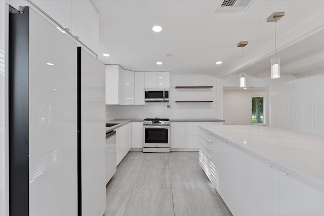 7807 Ella Lee Ln, Houston, TX 77063 - kitchen with stainless steel gas stove, open shelves, white cabinetry, light countertops, and recessed lighting