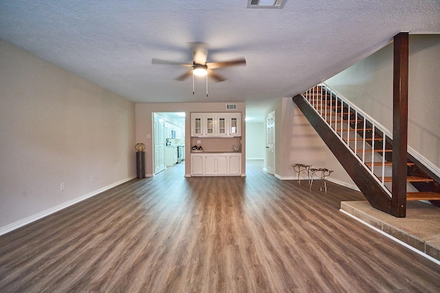10818 Briar Forest Dr Unit 34, Houston, TX 77042 - unfurnished living room with wood finished floors, stairway, a ceiling fan, and a textured ceiling