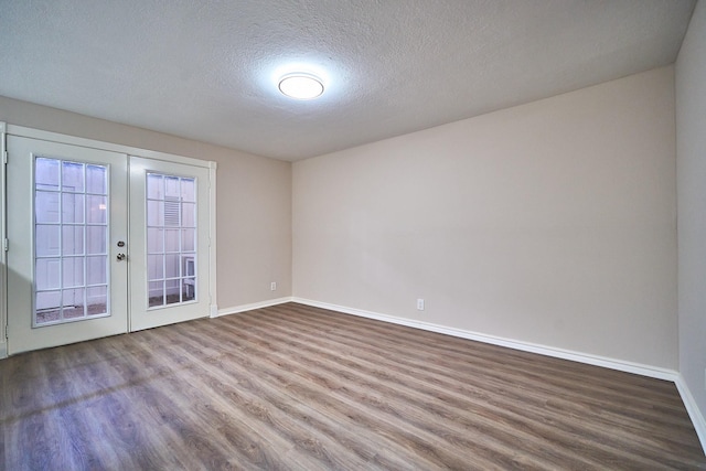 10818 Briar Forest Dr Unit 34, Houston, TX 77042 - spare room with wood finished floors, french doors, and a textured ceiling