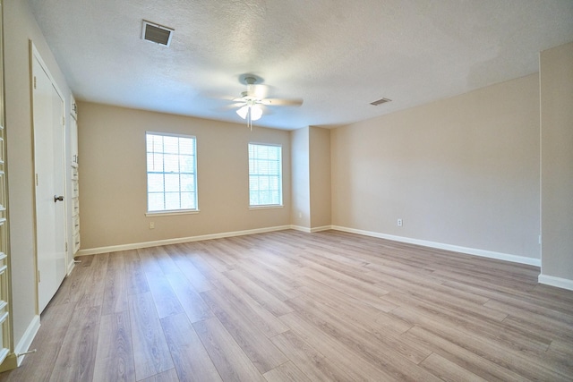 10818 Briar Forest Dr Unit 34, Houston, TX 77042 - unfurnished bedroom featuring light wood-type flooring, a textured ceiling, and a ceiling fan