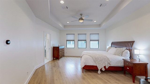 1767 Michigan St, Houston, TX 77006 - bedroom with light wood-style floors, a tray ceiling, recessed lighting, and a ceiling fan
