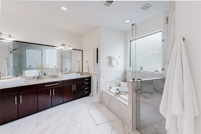 1767 Michigan St, Houston, TX 77006 - bathroom with a bath, vanity, a marble finish shower, marble finish floors, and plenty of natural light