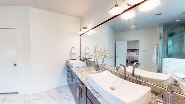 1767 Michigan St, Houston, TX 77006 - ensuite bathroom with double vanity, a marble finish shower, and marble look tiles