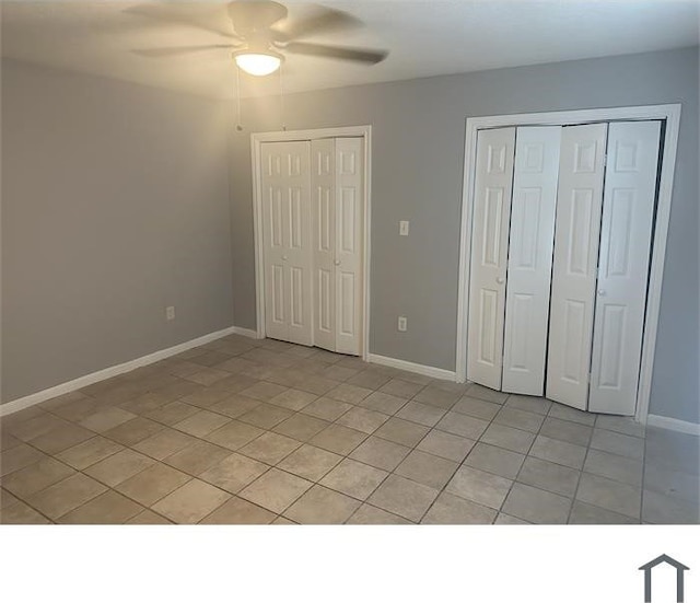 3629 Lydia St Unit A, Houston, TX 77021 - unfurnished bedroom featuring multiple closets, light tile patterned flooring, and a ceiling fan