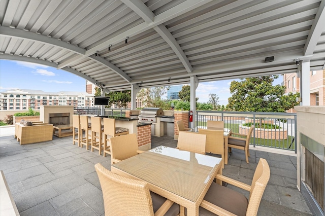 2207 Bancroft St Unit 1104, Houston, TX 77027 - view of patio with area for grilling, outdoor dining space, and a bar