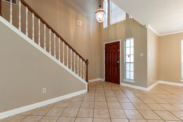 2611 Potomac Dr, League City, TX 77573 - foyer with stairs, ornamental molding, and light tile patterned floors