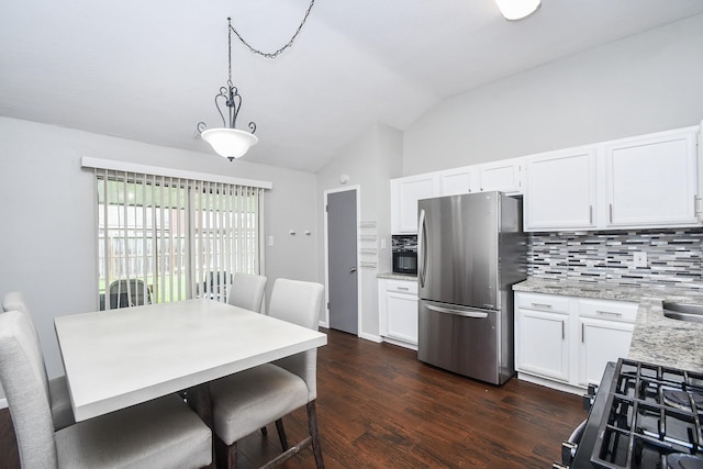 16810 Rockstone, Houston, TX 77084 - kitchen featuring freestanding refrigerator, vaulted ceiling, decorative backsplash, and white cabinets