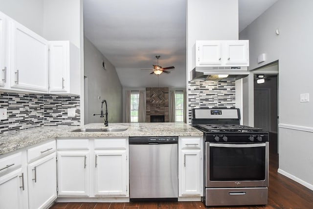 16810 Rockstone, Houston, TX 77084 - kitchen featuring appliances with stainless steel finishes, exhaust hood, a ceiling fan, and tasteful backsplash
